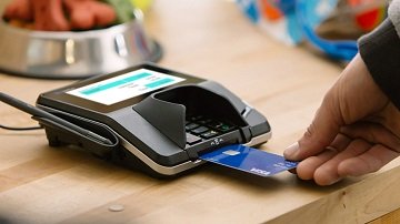 Person using Visa chip card at a chip-enabled terminal. Person using Visa chip card at a chip-enabled terminal.