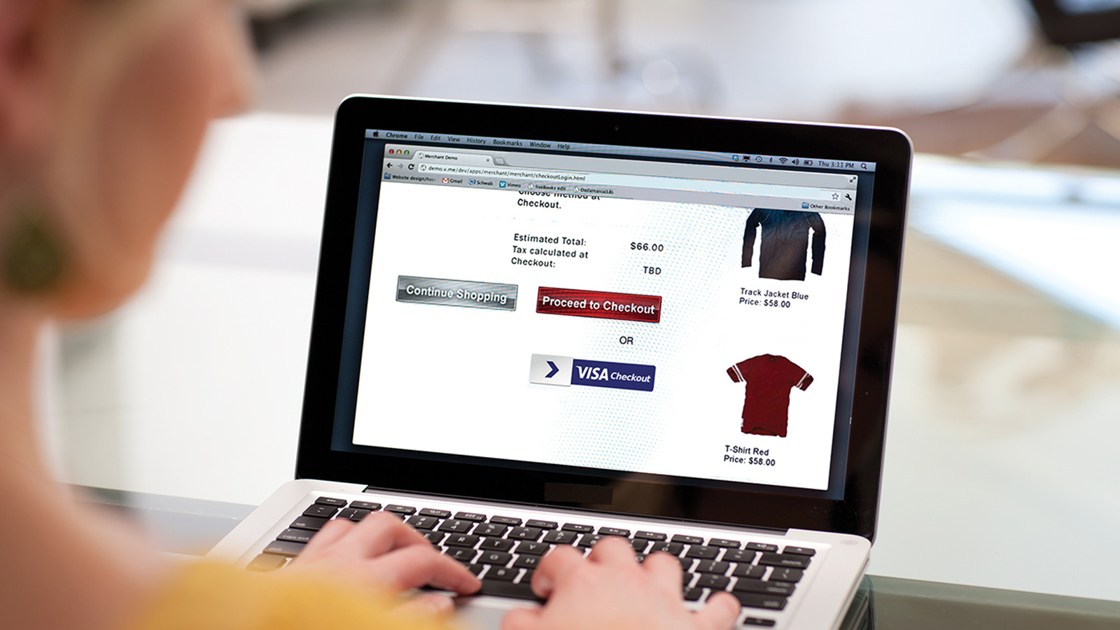 Woman on a laptop using the Visa Checkout option to complete an online purchase.