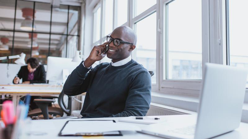young-man-talking-on-his-mobile-phone-in-office_800x450 young-man-talking-on-his-mobile-phone-in-office_800x450