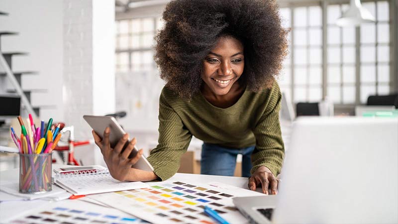 designer-working-in-studio-using-laptop-smart-phone-800x450