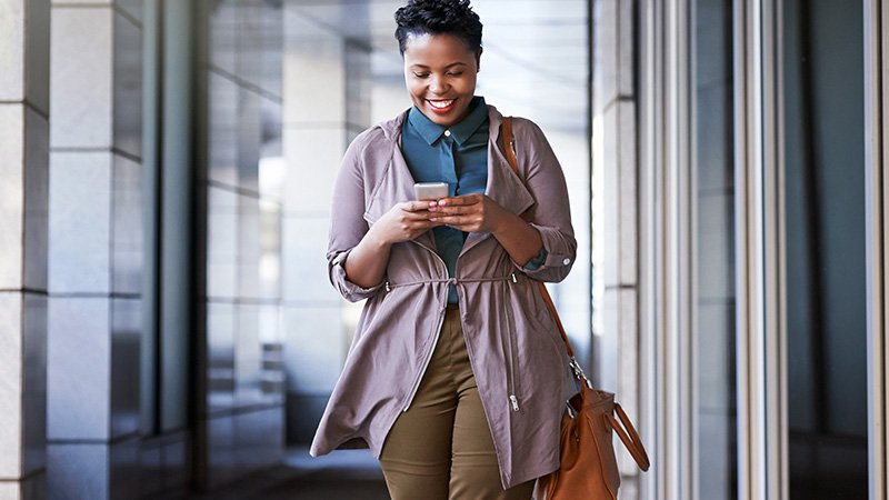 Woman smiling at a smart phone. Woman smiling at a smart phone.
