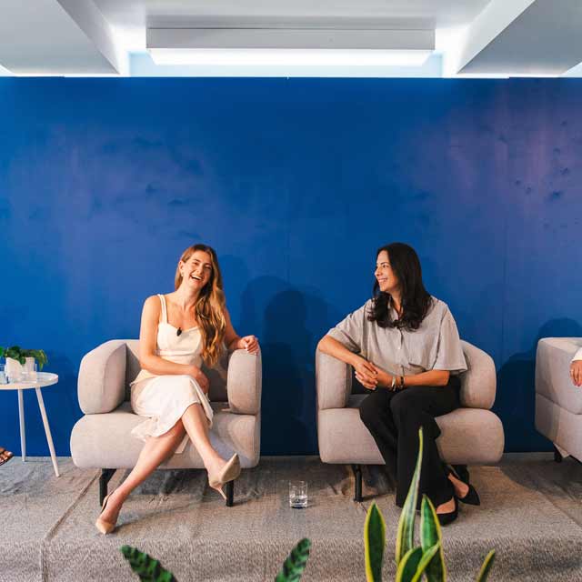 People sitting in chairs talking to each other