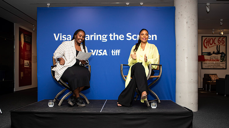 Image of two presenters at the Visa Sharing the Screen event, with the Visa logo and tiff logo on the backdrop.
