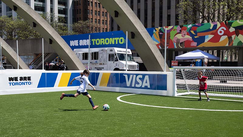Soccer park in Toronto with We are Toronto signage and Visa logo.