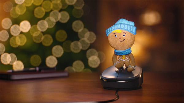 Gingerbread boy using computer mouse.