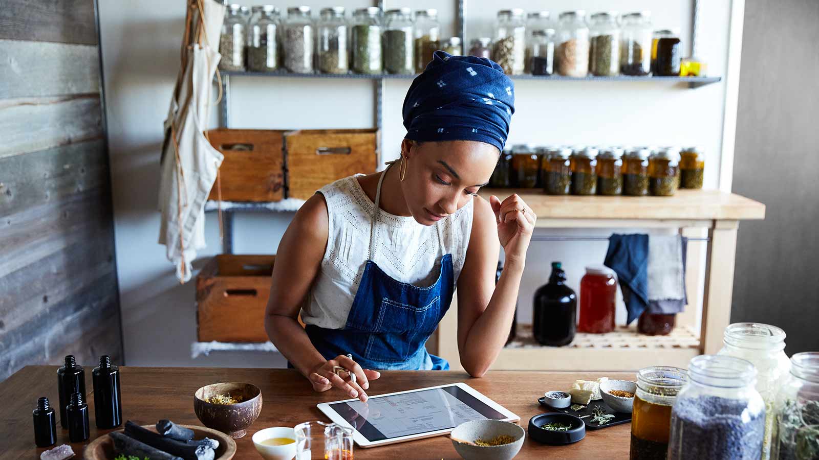 Tea shop owner using a tablet