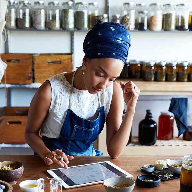 Tea shop owner using a tablet