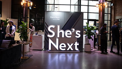 She’s Next, Empowered by Visa signage.