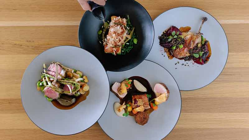 Four dishes served on a table