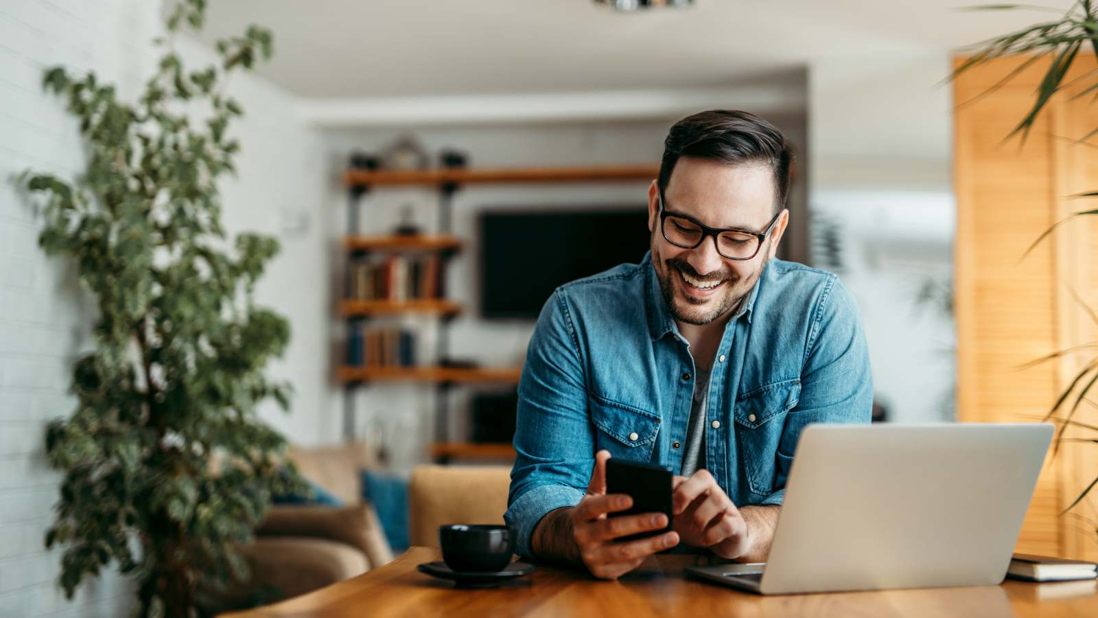 Man at home looking at phone