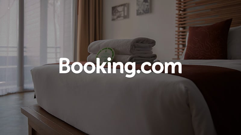 Hotel room with Booking.com logo superimposed on it.